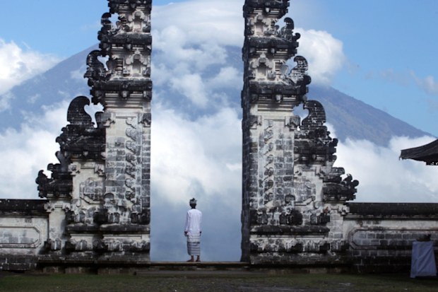 A Balinese man watches Mount Agung volcano as he stands at a temple in Karangasem, Bali. (AP)