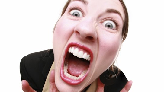 GENERIC A fisheye shot of a very angry woman. woman; person; female; business; businesswoman; suit; mad; frustrated; stressed; angry; stressed; stressed out; fisheye; distorted; silly; crazy; insane; isolated; full body; caucasian; blue eyes; mouth open; character; face; facial expression; 30; young adult; mouth; teeth; isolated; isolated on white; emotion; emotional; aggravated; screaming