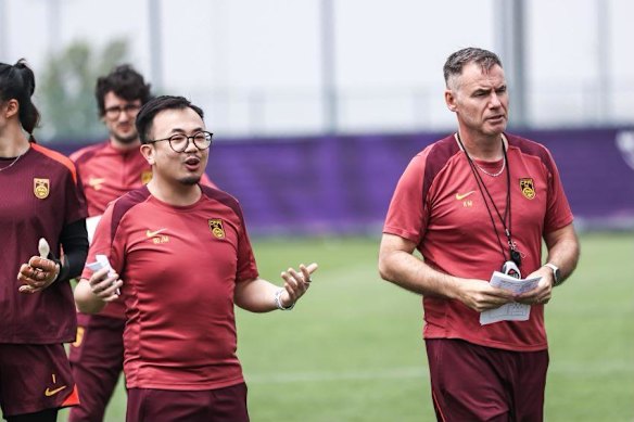 China coach Ante Milicic with his interpreter, Tracy Gu (left).