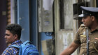Sri Lankan policemen check the identity card of a person carrying a back-pack, in Colombo on Monday.