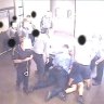 Still from CCTV footage of a young person being held on the ground, from a 2016 Queensland youth detention report.
