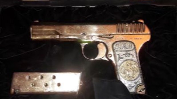 A gold-plated pistol Russian police found when they arrested a top official in the Dagestan region on suspicion of embezzlement.