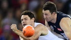 Lachie Neale of the All Stars is tackled by Victoria's Patrick Dangerfield