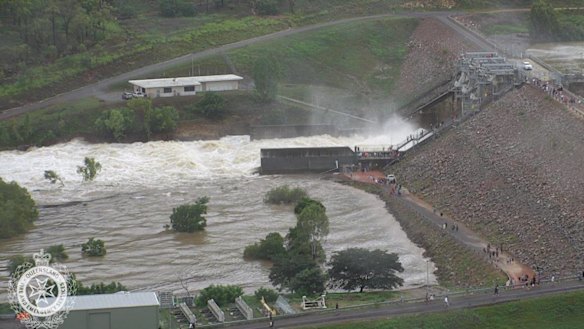 Water flows out of the Ross River Dam in Townsville after the floodgates were opened on Sunday night