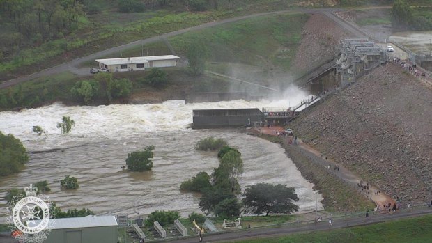 Water flows out of the Ross River Dam in Townsville after the floodgates were opened on Sunday night