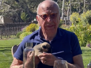Cuddly: Rupert Murdoch with his daughter Grace’s new puppy in California last week.