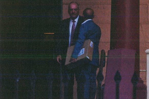 Surveillance footage shows Jo Alha, carrying a box, meeting Daryl Maguire at Parliament in 2017.