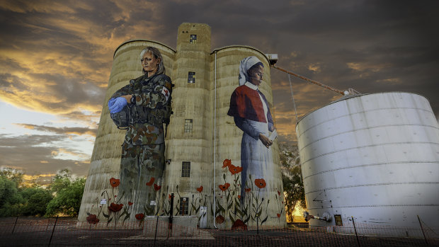 Art from the heart: the mural the people of Devenish, in northern Victoria funded on its old silos depicts two service women, 100 years apart: a WWI nurse and a modern day army medic. 