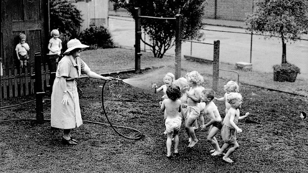 Keeping cool: hosing down children at the Golden Fleece Kindergarten on a hot day in October 1935.