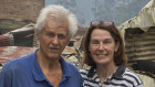 Former Australian rugby union player Anthony Abrahams and wife Wendy Sillence stand amid the wreckage of their barn, in the NSW Southern Highlands.