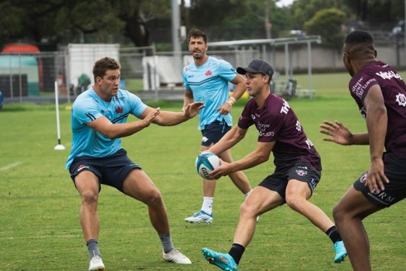 Daly Cherry-Evans takes on the Waratahs defence at a combined session in 2022.