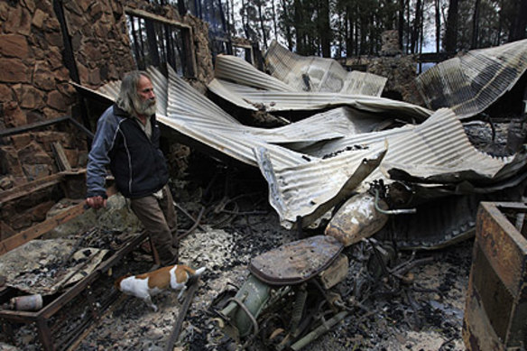 Rob Hallett and his dog Ted in the ruins of the shed.