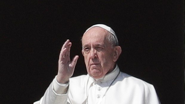 Pope Francis delivers his blessing from the window of his studio overlooking an empty St Peter's Square, at the Vatican.