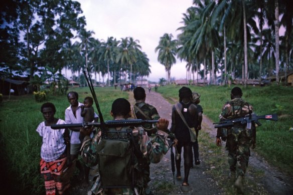 PNG forces patrol villages with their BRF allies.