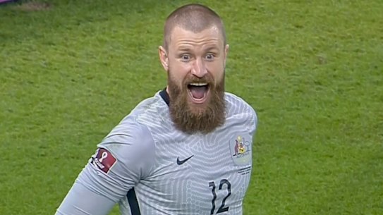 Australian goalkeeper Andrew Redmayne celebrates after making the crucial  save in the penalty shootout against Peru
