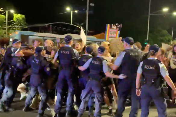 NSW Police physically intervene to remove protesters blocking the road during a snap rally on Oxford Street.
