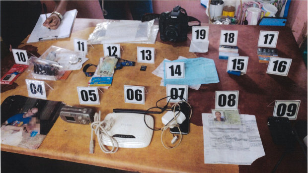 Exhibits seized from the home in the Philippines, including the photo.