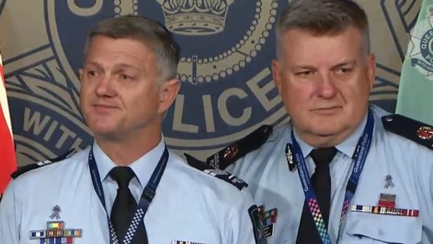 Queensland Senior Constable Neil Scutts, left, fights back tears as he fronts media with Assistant Commissioner Mike Condon.
