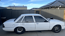 The white 1986 VK Holden Commodore with no rego was one of two vintage cars stolen from the Virginia property.
