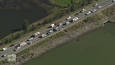 A wider aerial view of the scene on Beaudesert Boonah Road and in Wyaralong Dam.