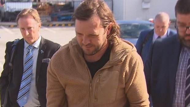 Tobias Moran in police custody at Perth Airport.