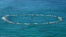 Surfers took part in a paddle out in honour of the former Bondi Rescue lifeguard.