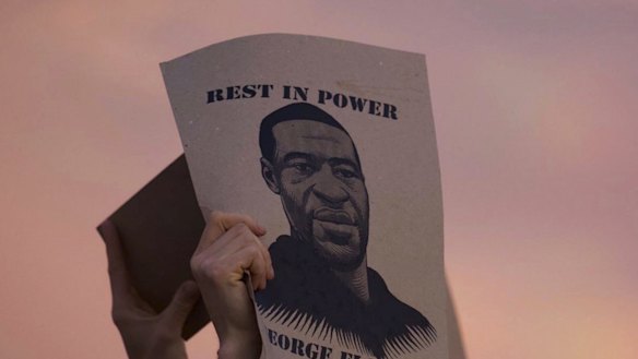 A protester holds a sign with an image of George Floyd during protests in Minneapolis against the death of Floyd in Minneapolis police custody earlier in the week. 