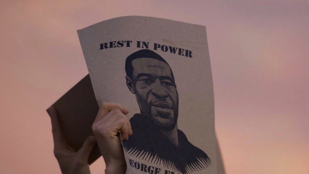 A protester holds a sign with an image of George Floyd during protests in Minneapolis against the death of Floyd in Minneapolis police custody earlier in the week. 