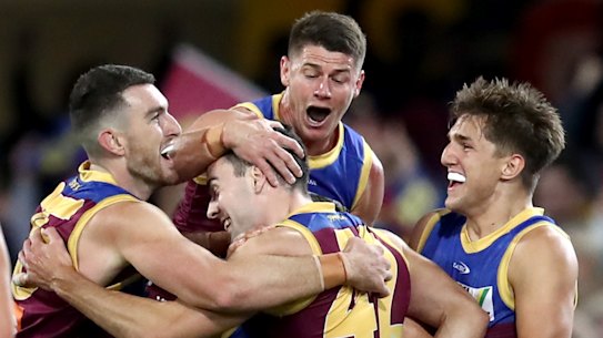 Lion James Madden is swarmed by his Lions teammates after a goal.