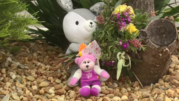 Flowers and soft toys were left at the scene on Tuesday.