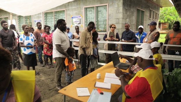 The first people to vote in the Bougainville independence referendum in the capital Arawa were the former commanders of the BRA (Bougainville Revolutionary Army) Ishmael Torama and Chris Uma, centre, standing with their children.