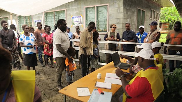 The first people to vote in the Bougainville independence referendum in the capital Arawa were the former commanders of the BRA (Bougainville Revolutionary Army) Ishmael Torama and Chris Uma, centre, standing with their children.