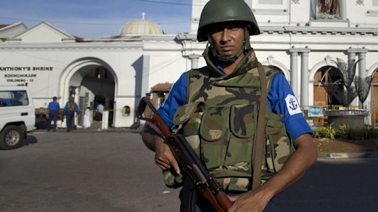 Sri Lankan air force officers and clergy stand outside St. Anthony's Shrine, a day after a blast in Colombo, Sri Lanka. 