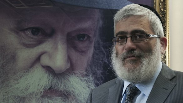 'Diamond' Joe Gutnick in front of a painting of Rabbi Menachem Mendel Schneerson, in his Melbourne office in 2013.