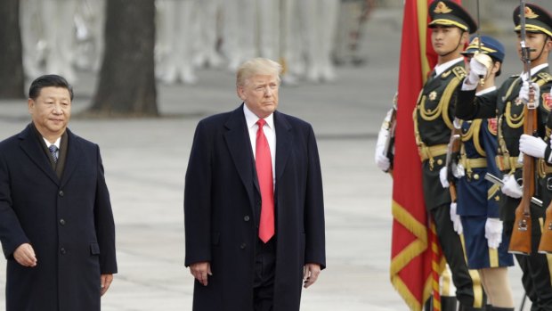 President Donald Trump, right, and China's President Xi Jinping walk past members of the People's Liberation Army at a welcome ceremony in Beijing in 2017.