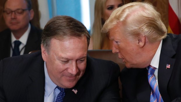 President Donald Trump speaks with Secretary of State Mike Pompeo in 2018. 