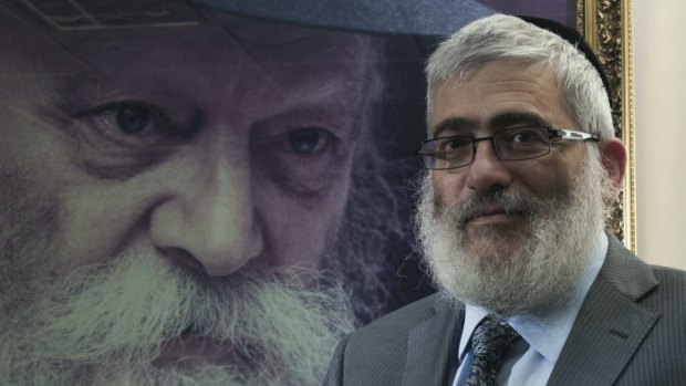 'Diamond' Joe Gutnick in front of a painting of Rabbi Menachem Mendel Schneerson, in his Melbourne office in 2013.