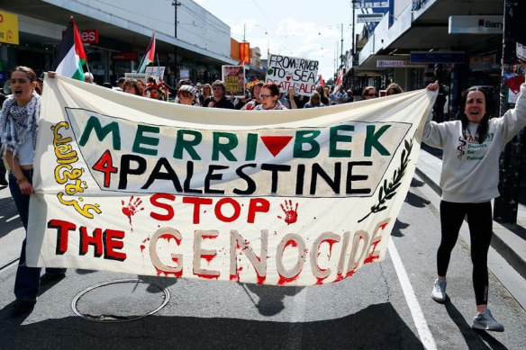 Protesters in Coburg outside the office of Labor MP Peter Khalil, with a banner featuring the red inverted triangle associated with Hamas.