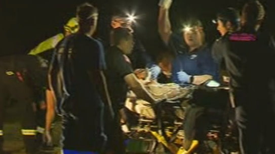 A person is treated after being rescued from a rip at North Curl Curl Beach late on Sunday.