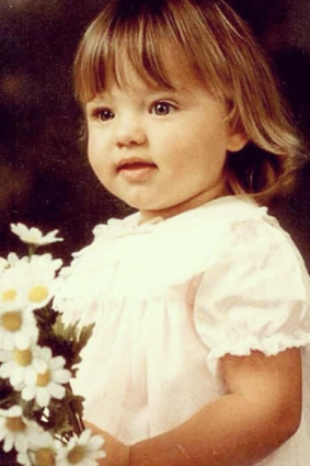 Miranda, here aged 3, sporting 
frills and flowers. She still loves a pretty dress. 