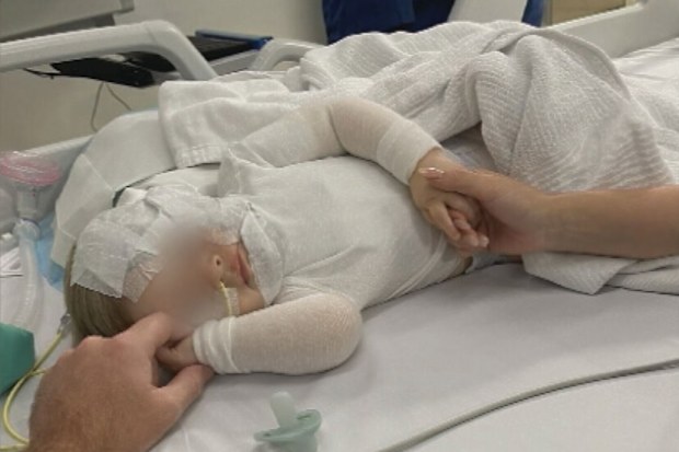 A baby boy is in hospital recovering from a horrific burns after a stranger poured hot coffee over his head in a Brisbane park. The infant, who cannot be identified under Queensland law as a child victim of crime, has suffered burns to his face and chest. The nine-month old and his mother were ambushed as they were enjoying a picnic at Hanlon Park in Stones Corner at about midday yesterday. 