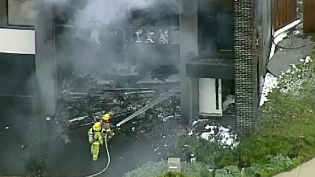 Firefighters work on the house fire in Officer.