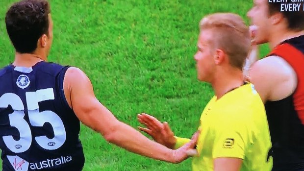 Touch too much: Carlton's Ed Curnow makes physical contact with an umpire in Saturday's match against Essendon.