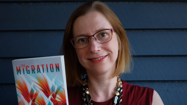 Queensland author Dr Helen Marshall with her book The Migration, which is expected to be turned into a television series.