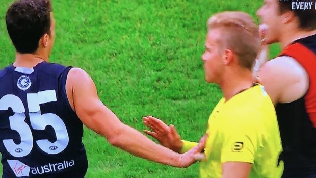 Touch off: Carlton's Ed Curnow makes physical contact with an umpire in Saturday's match against Essendon.