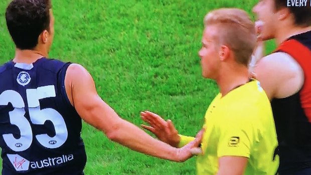 Ed Curnow makes contact with an umpire during the match against Essendon.