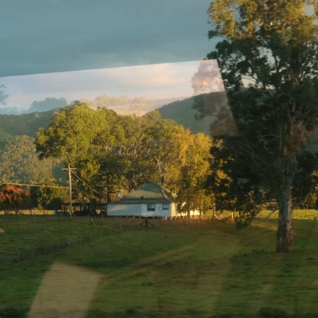 The bucolic view of the hills near Gloucester is reflected in the windows of the XPT train.