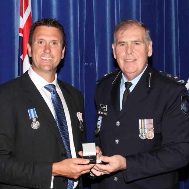 Dan Purdie receives a policing award during his time in the police service. 
