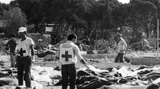 Red Cross and social workers at the Sabra camp work among the victims of the massacre.