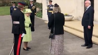 The Queen arrives at the memorial service for the RAAF in Runnymede, greeted by high commissioner George Brandis, far right.